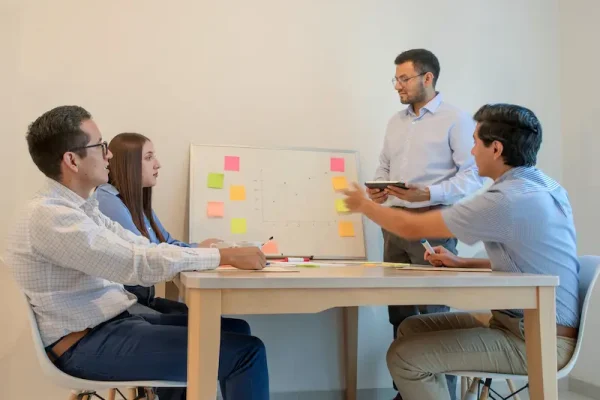 a-group-of-people-around-a-table-2025-03-06-02-11-38-utc